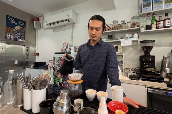 Daniel Chao makes a drink at his coffee shop in Macao on Dec. 13, 2024. (AP Photo/Kanis Leung)