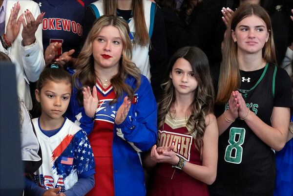 People listen as President Donald Trump speaks before signing an executive order barring transgender female athletes from competing in women's or girls' sporting events, in the East Room of the White House, Wednesday, Feb. 5, 2025, in Washington. (AP Photo/Alex Brandon)