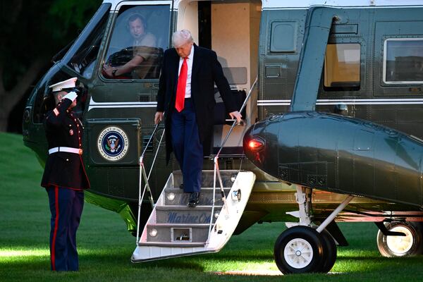 President Donald Trump arrives on the South Lawn of the White House, Thursday, May 22, 2025, in Washington, after attending a crypto dinner at Trump National Golf Club Washington DC. (AP Photo/John McDonnell)