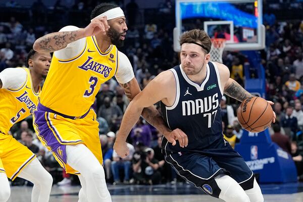 FILE - Dallas Mavericks guard Luka Doncic drives against Los Angeles Lakers forward Anthony Davis (3) during the first half of an NBA basketball game in Dallas, Tuesday, Dec. 12, 2023. (AP Photo/LM Otero, File)