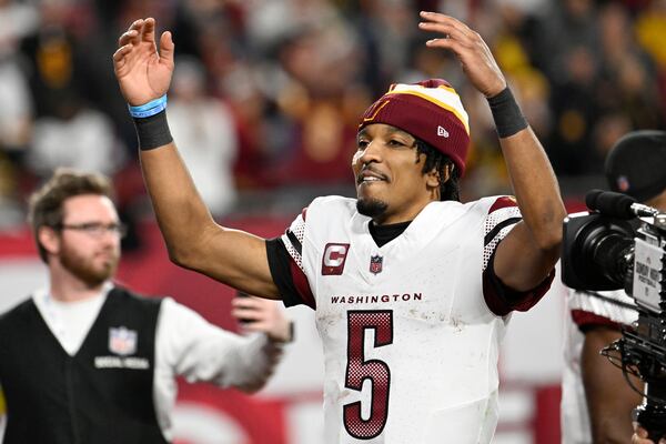 Washington Commanders quarterback Jayden Daniels (5) celebrates after an NFL wild-card playoff football game against the Tampa Bay Buccaneers in Tampa, Fla., Sunday, Jan. 12, 2025. (AP Photo/Jason Behnken)