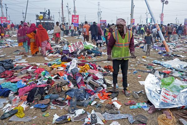 A volunteer helps people to look for their valuables after a stampede when Hindu devotees rushed to take a holy bath in the Sangam, the confluence of the Ganges, the Yamuna and the mythical Saraswati rivers, on "Mauni Amavasya" or new moon day during the Maha Kumbh festival in Prayagraj, India, Wednesday, Jan. 29, 2025. (AP Photo/Deepak Sharma)