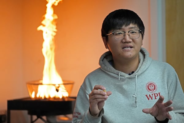 Luqing Zhu, a PhD student in the department of Fire Protection Engineering, describes an experiment using burning embers and wind in a lab at Worcester Polytechnic Institute, Wednesday, Jan. 15, 2025, in Worcester, Mass. (AP Photo/Robert F. Bukaty)