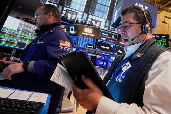 Specialist Anthony Matesic, left, and trader Michael Capolino work on the floor of the New York Stock Exchange, Tuesday, May 20, 2025. (AP Photo/Richard Drew)