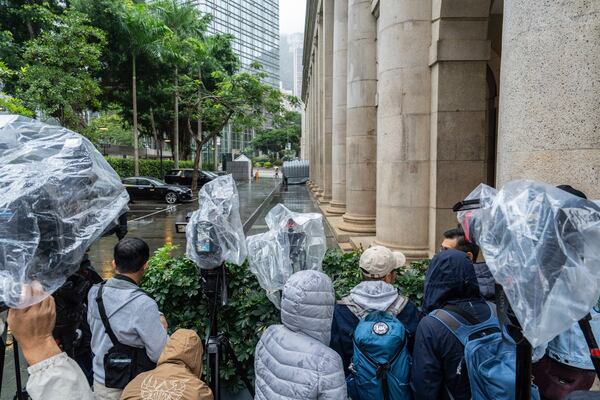 Members of the media wait outside the Court of Final Appeal in Hong Kong, Thursday, Mar 6, 2025. Three former organizers of Hong Kong's annual vigil in remembrance of the 1989 Tiananmen Square crackdown won their bid at the top court on Thursday to overturn their conviction over their refusal to provide information to police, marking a rare victory for the city's pro-democracy activists. (AP Photo/Chan Long Hei)