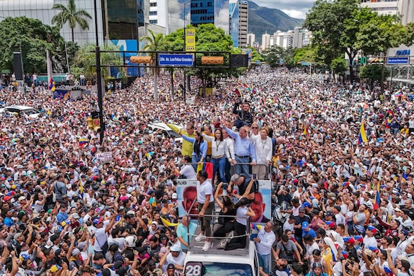 FILE - Opposition leader Maria Corina Machado and opposition candidate Edmundo Gonzalez ride atop a truck during a protest against official presidential election results declaring President Nicolas Maduro the winner in Caracas, Venezuela, July 30, 2024, two days after the vote. (AP Photo/Matias Delacroix, File)