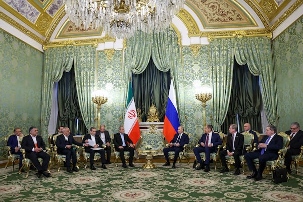 Russian President Vladimir Putin, center right, and Iranian President Masoud Pezeshkian, center left, attend talks at the Kremlin in Moscow, Russia, Friday, Jan. 17, 2025. (Evgenia Novozhenina/Pool Photo via AP)