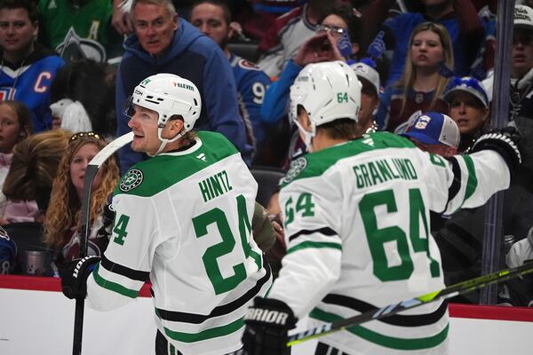 Dallas Stars center Roope Hintz, left, celebrates after scoring with center Mikael Granlund in the second period of Game 6 of an NHL hockey first-round playoff series against the Colorado Avalanche, Thursday, May 1, 2025, in Denver. (AP Photo/David Zalubowski)