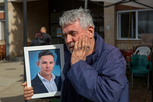 Tomco Stojanov who said his son Andrej died in the fire holds his portrait outside a hospital in the town of Kocani, North Macedonia, Monday, March 17, 2025, following a massive fire in the nightclub early Sunday. (AP Photo/Visar Kryeziu)