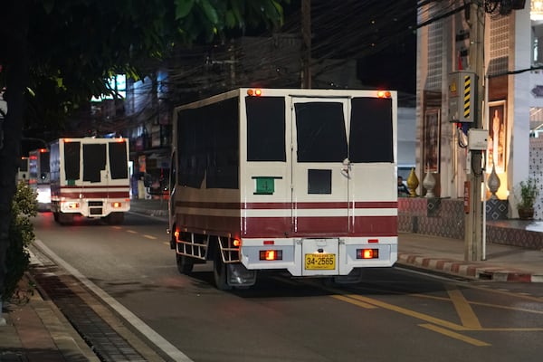 This photo provided by Thailand's daily web newspaper Prachatai shows trucks with black tape covering the windows leave a detention center in Bangkok, Thailand Thursday, Feb. 27, 2025.(Nuttaphol Meksobhon/Prachatai via AP)