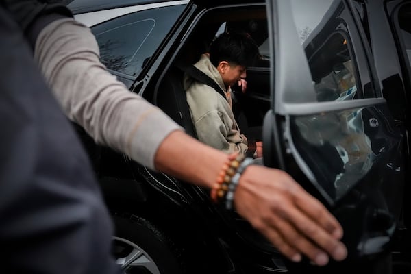 A deportation officer with Enforcement and Removal Operations in U.S. Immigration and Customs Enforcement's New York City field office puts Wilmer Patricio Medina-Medina in the back of a car after arresting him during an early morning operation, Tuesday, Dec. 17, 2024, in the Bronx borough of New York. (AP Photo/Julia Demaree Nikhinson)