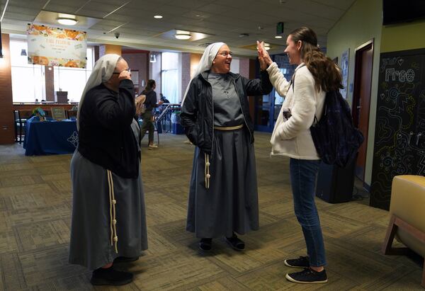 Sister Catherine Lynn Forsythe, left, and Sister Joan Paule Portenlanger of the Franciscan Sisters, T.O.R. of Penance of the Sorrowful Mother, talk with students on campus at Franciscan University, in Steubenville, Ohio, Thursday, Nov. 7, 2024. (AP Photo/Jessie Wardarski)