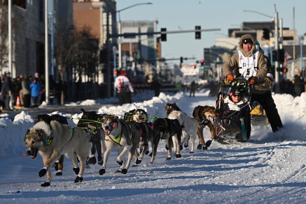 FILE - Mats Pettersson, from Sweden, makes the corner onto Cordova Street during the Iditarod Trail Sled Dog Race ceremonial start in Anchorage, Alaska, on Saturday, March 2, 2024. (Bob Hallinen/Anchorage Daily News via AP, File)