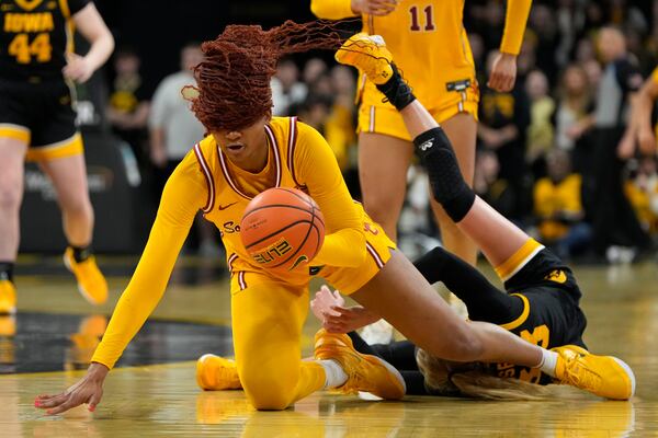 Southern California forward Kiki Iriafen, left, steals the ball from Iowa guard Lucy Olsen, right, during the first half of an NCAA college basketball game, Sunday, Feb. 2, 2025, in Iowa City, Iowa. (AP Photo/Charlie Neibergall)