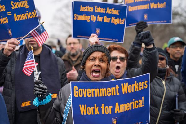 Sona Anderson of San Diego, center, shouts her support for civil service workers as activists protest the policies of President Donald Trump and Elon Musk outside the Capitol in Washington, Tuesday, Feb. 11, 2025. (AP Photo/J. Scott Applewhite)