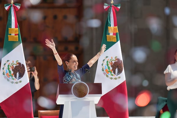 President Claudia Sheinbaum gestures to supporters at a rally she convened to welcome U.S. President Donald Trump's decision to postpone tariffs on Mexican goods for one month at the Zocalo, Mexico City's main square, Sunday, March 9, 2025. (AP Photo/Eduardo Verdugo)