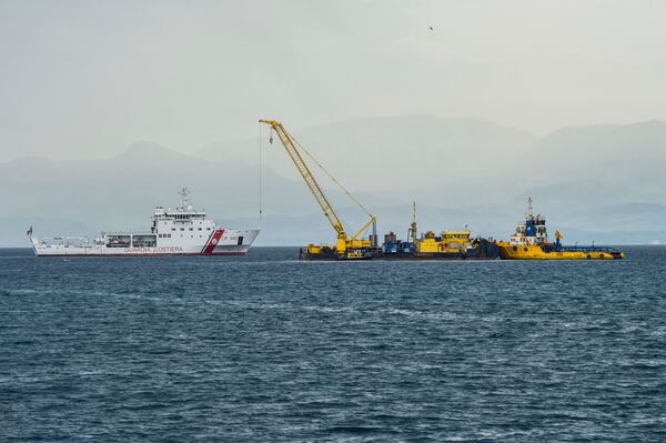 Italian Coast Guard's Luigi Dattilo patrol boat, left, assists the multi-purpose floating work barge Hebo Lift 2 monitoring the stretch of sea off Porticello, near Palermo, Sicily, Italy, Sunday, May 4, 2025, where the British superyacht Bayesian sunk on August 19, 2024 as the operations for its recovery start. (AP Photo/Salvatore Cavalli)