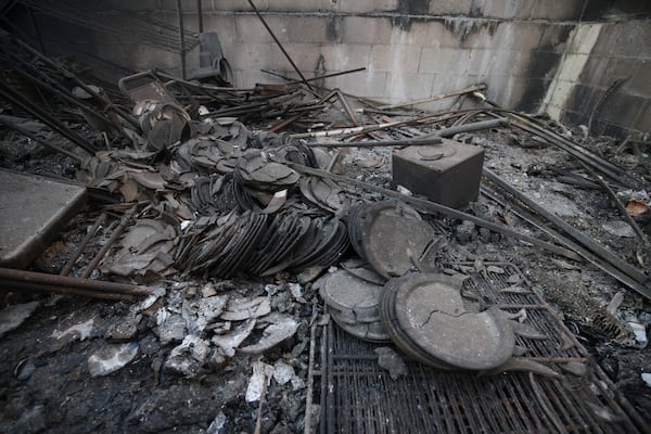 Dishes destroyed by the Eaton Fire lie on the ground on Sunday, Jan. 12, 2025, in Altadena, Calif. (AP Photo/Ethan Swope)