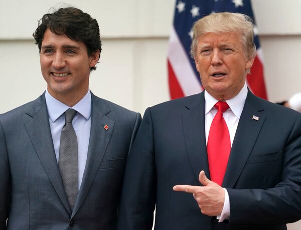 FILE - President Donald Trump and Canadian Prime Minister Justin Trudeau pose for a photo as Trudeau arrives at the White House in Washington, on Oct. 11, 2017. (AP Photo/Carolyn Kaster, File)