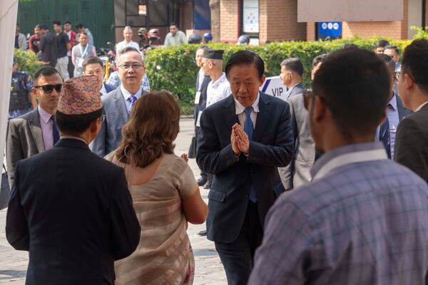 A Chinese delegate arrives to participate in an environment conference named Sagarmatha Sambaad (Mount Everest Dialogue) in Kathmandu, Nepal, Friday, May 16, 2025. (AP Photo/Niranjan Shrestha)