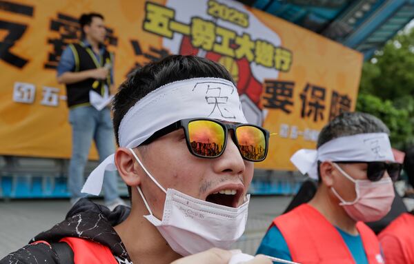 A protester shouts slogans during a May Day rally in Taipei, Taiwan, Thursday, May 1, 2025. (AP Photo/Chiang Ying-ying)