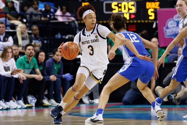 Notre Dame's Hannah Hidalgo (3) handles the ball as Duke's Delaney Thomas (12) defends during the second half of an NCAA college basketball game in the semifinals of the Atlantic Coast Conference tournament in Greensboro, N.C., Saturday, March 8, 2025. (AP Photo/Ben McKeown)