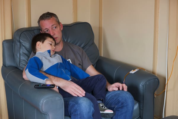 Jake Heinrichs sits with his 3-year-old son, Sam, during his infusion treatment with an experimental anti-amyloid Alzheimer's drug in New York, on Wednesday, March 12, 2025. (AP Photo/Heather Khalifa)