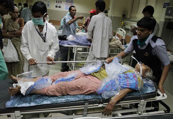 FILE - People wheel in a heat stroke patient, covered in ice cube bags, at a hospital in Ahmadabad, India, May 21, 2010. (AP Photo/Ajit Solanki, File)