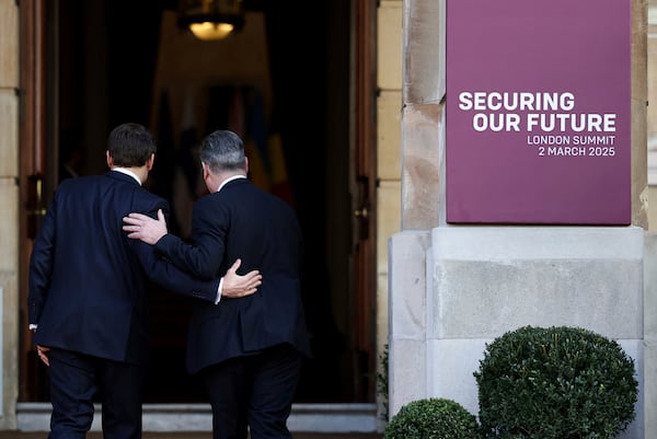 Britain's Prime Minister Keir Starmer, right, welcomes French President Emmanuel Macron to the European leaders' summit to discuss Ukraine, at Lancaster House, London, Sunday March 2, 2025. (Toby Melville/Pool via AP)