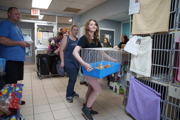 The Bruzdzinski family adopt chicks at First State Animal Center and SPCA on Friday, May 16, 2025, in Camden, Del. (AP Photo/Mingson Lau)