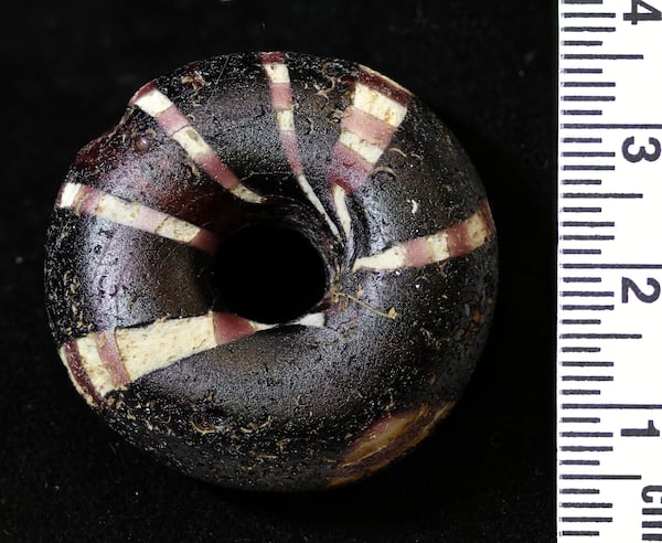 This photo provided by Bournemouth University in January 2025 shows a decorated glass bead imported from Germany found in an Iron Age Celtic cemetery as part of the Durotriges tribe project dig in Dorset, southwest England. (Bournemouth University via AP)