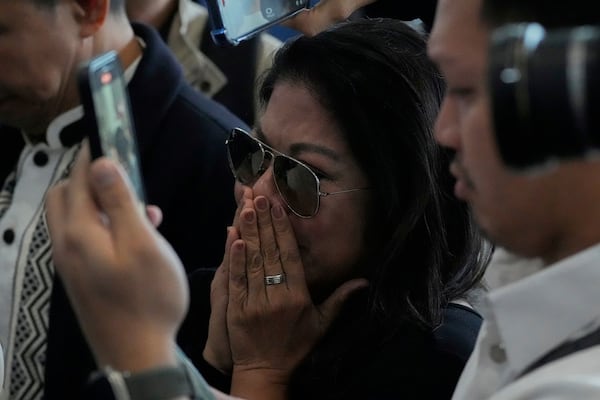 A supporter of former President Rodrigo Duterte reacts upon finding out he was arrested, at the airport in Manila, Philippines, Tuesday, March 11, 2025. (AP Photo/Aaron Favila)