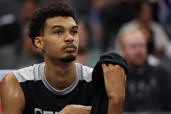 FILE - San Antonio Spurs center Victor Wembanyama sits on the bench during an NBA basketball game against the Sacramento Kings in Sacramento, Calif, Sunday, Dec. 1, 2024. (AP Photo/Jed Jacobsohn, File)