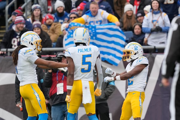 Los Angeles Chargers wide receiver Derius Davis (12) celebrates after his touchdown against the New England Patriots during the first half of an NFL football game, Saturday, Dec. 28, 2024, in Foxborough, Mass. (AP Photo/Michael Dwyer)