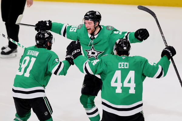 Dallas Stars' Tyler Seguin (91), Thomas Harley (55) and Cody Ceci (44) celebrate after Harley scored in overtime in Game 6 of a second-round NHL hockey playoff series against the Winnipeg Jets in Dallas, Saturday, May 17, 2025. (AP Photo/Gareth Patterson)