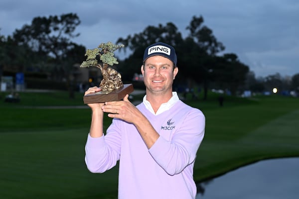 Harris English holds up the trophy after winning the Farmers Insurance Open golf tournament at Torrey Pines Saturday, Jan. 25, 2025, in San Diego. (AP Photo/Denis Poroy)