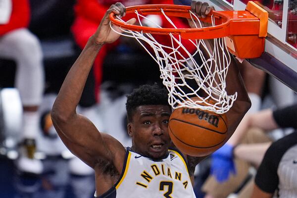 Indiana Pacers center Thomas Bryant (3) gets a basket on a dunk against the Atlanta Hawks during the second half of an NBA basketball game in Indianapolis, Saturday, Feb. 1, 2025. (AP Photo/Michael Conroy)