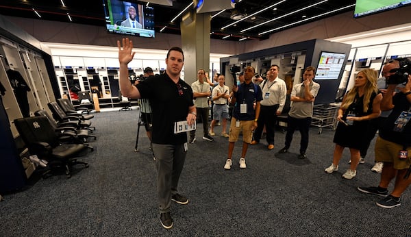 New York Yankees director of baseball operations Matthew Ferry, left, talks with the media in the newly completed Yankees clubhouse during a tour of the upgraded team spring training facilities Thursday, Feb 13, 2025, at George M. Steinbrenner Field in Tampa, Fla. (AP Photo/Steve Nesius)