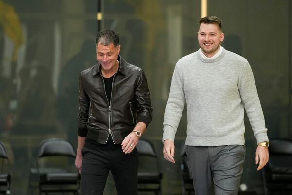 Los Angeles Lakers' Luka Doncic, right, walks to the podium with general manger Rob Pelinka during an introductory NBA basketball press conference Tuesday, Feb. 4, 2025, in El Segundo, Calif. (AP Photo/Jae C. Hong)