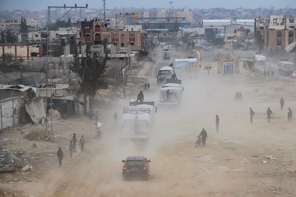 Humanitarian aid trucks enter through the Kerem Shalom crossing from Egypt into the Gaza Strip, in Rafah, Wednesday, Jan. 22, 2025, days after the ceasefire deal between Israel and Hamas came into effect. (AP Photo/Jehad Alshrafi)