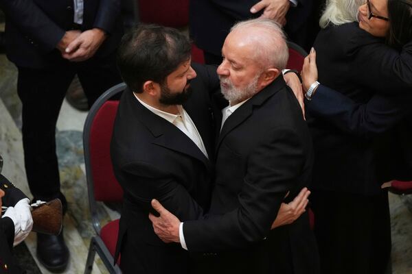 Brazil's President Luiz Inacio Lula Da Silva, right, and Chile's President Gabriel Boric embrace during funeral ceremonies for former Uruguayan President Jose Mujica at the Legislative Palace in Montevideo, Uruguay, Thursday, May 15, 2025. (AP Photo/Matilde Campodonico)