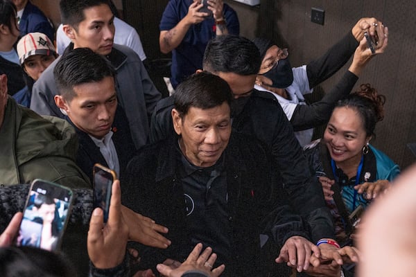 Former President of the Philippines Rodrigo Duterte arrives inside the Southorn Stadium during a thanksgiving gathering organized by Hong Kong-based Filipino workers for the former populist president in Hong Kong on Sunday, March 9, 2025. (AP Photo/Vernon Yuen)