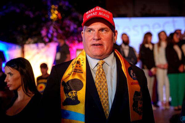 U.S. activist Brian Brown stands as supporters of presidential candidate George Simion celebrate the exit poll results at the headquarters of the Alliance for the Unity of Romanians (AUR) after polls closed for the first round of the country's presidential election redo in Bucharest, Romania, Sunday, May 4, 2025. (AP Photo/Andreea Alexandru)