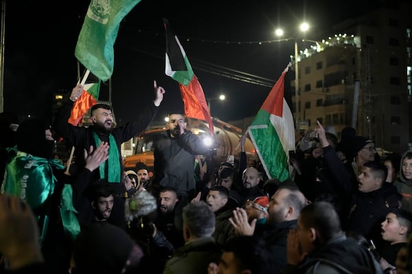 Palestinians celebrate a ceasefire agreement between Hamas and Israel in the West Bank city of Beitunia, on Sunday, Jan. 19, 2025. (AP Photo/Leo Correa)