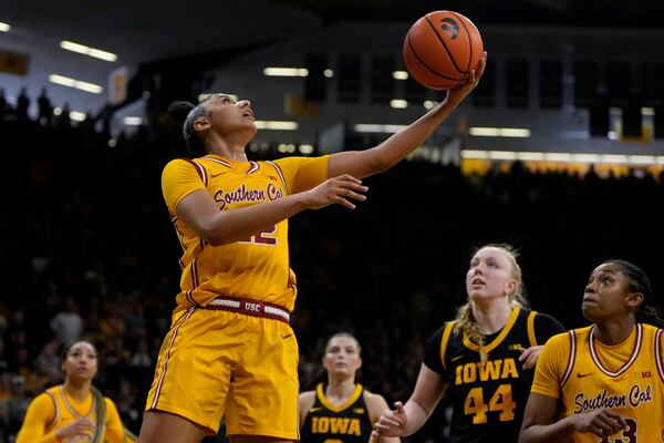 Southern California guard JuJu Watkins, front left, drives to the basket during the first half of an NCAA college basketball game against the Iowa, Sunday, Feb. 2, 2025, in Iowa City, Iowa. (AP Photo/Charlie Neibergall)