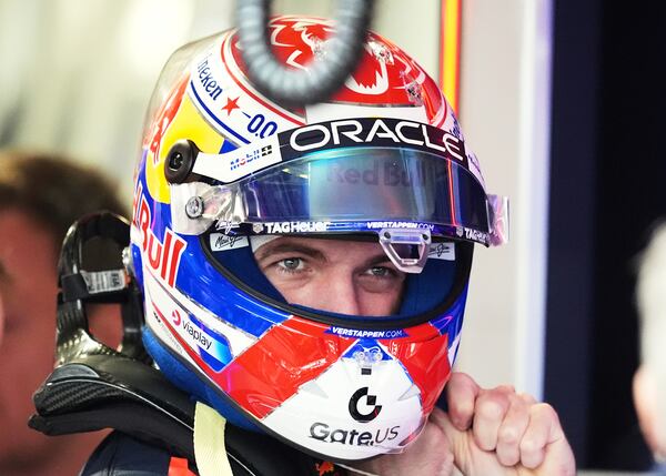 Red Bull driver Max Verstappen of the Netherlands puts on his helmet in the pits during a practice session for the Formula One Miami Grand Prix auto race, Friday, May 2, 2025, in Miami Gardens, Fla. (AP Photo/Rebecca Blackwell)