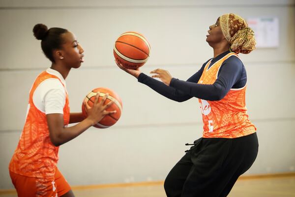 A player wearing a headscarf warms-up before a basketball game, in Aubervilliers near Paris, Sunday, April 27, 2025. (AP Photo/Thomas Padilla)