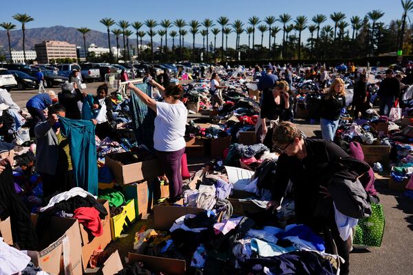 Items are laid out at an aid center for people affected by wildfires at Santa Anita Park Monday, Jan. 13, 2025, in Arcadia, Calif. (AP Photo/Carolyn Kaster)