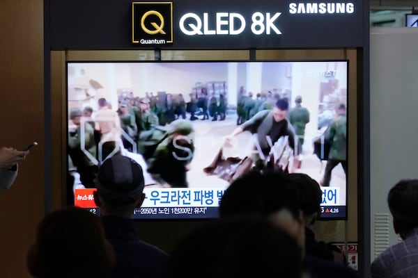 FILE - A TV screen at Seoul Railway Station in South Korea, on Oct. 21, 2024, shows an image of soldiers believed to be from North Korea standing in line to receive supplies from Russia. (AP Photo/Ahn Young-joon, File)