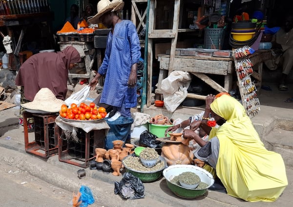 A man sells tomatoes at the main market in Maiduguri, Nigeria, Saturday, March 15, 2025. (AP Photo/Joshua Olatunji)